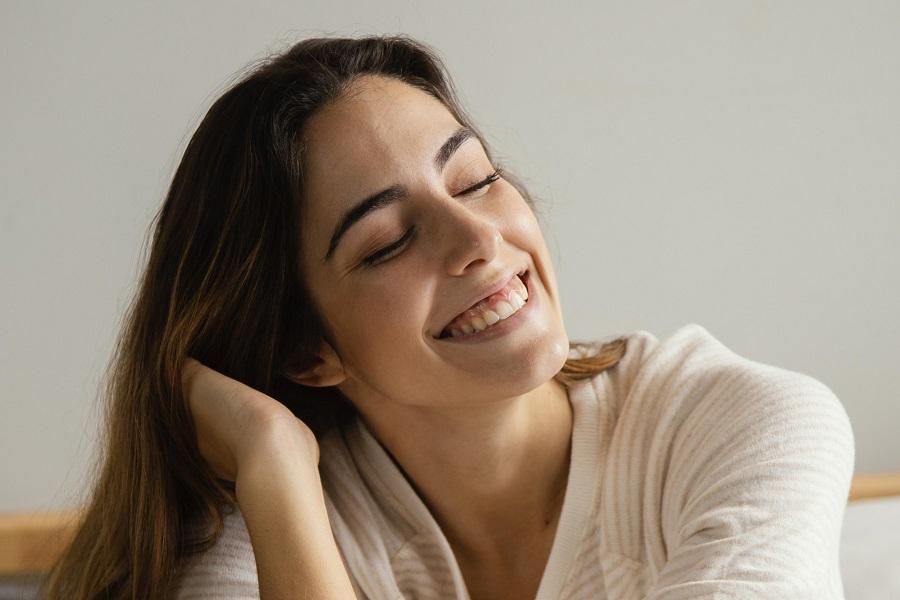 smiley-woman-bed-home